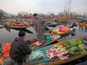Kashmiri vendors sell vegetables at the floating vegetable market